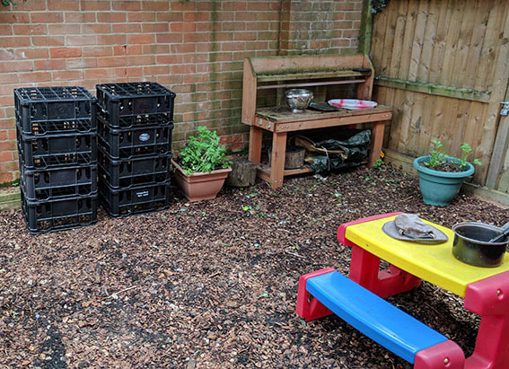 The outdoor mud kitchen and colourful picnic bench at Mulbarton nursery