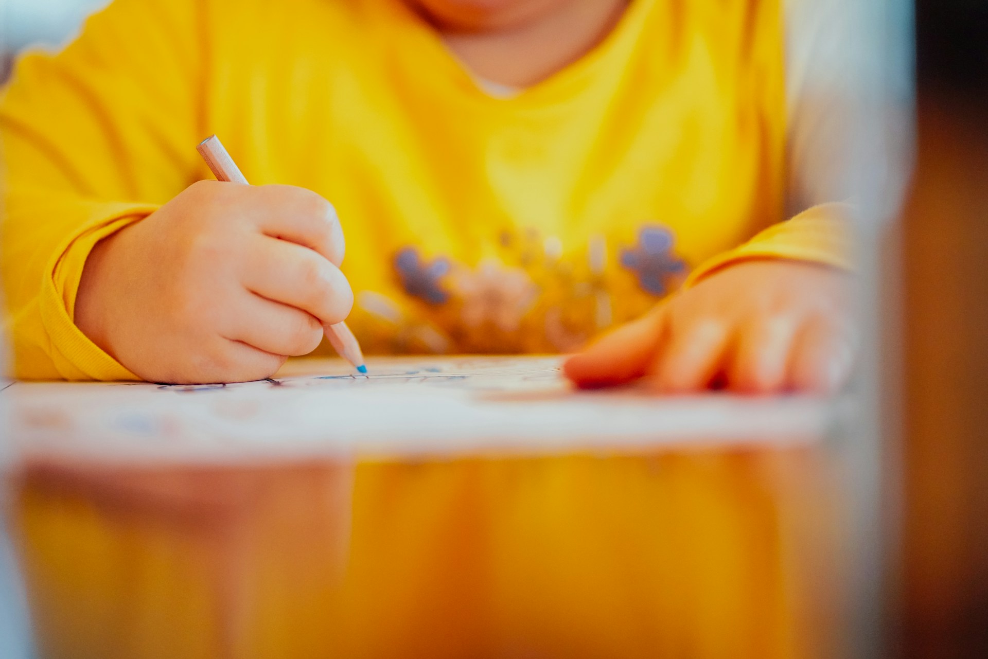 A child drawing with a pencil